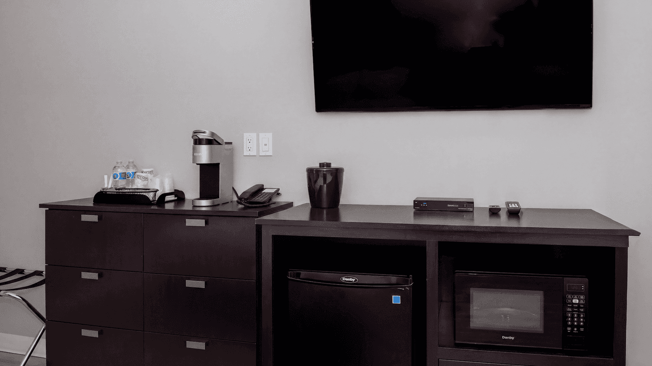 In-room coffee station, mini fridge and microwave at Coast Innisfail Hotel