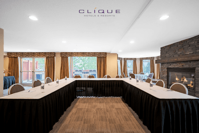 Meeting room at Falcon Crest Lodge is set up with a U-shaped conference table and chairs, ready for presentations