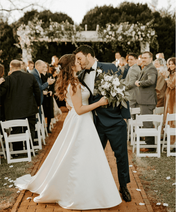 Bride and Groom kissing in wedding ceremony in Inn at Willow Grove