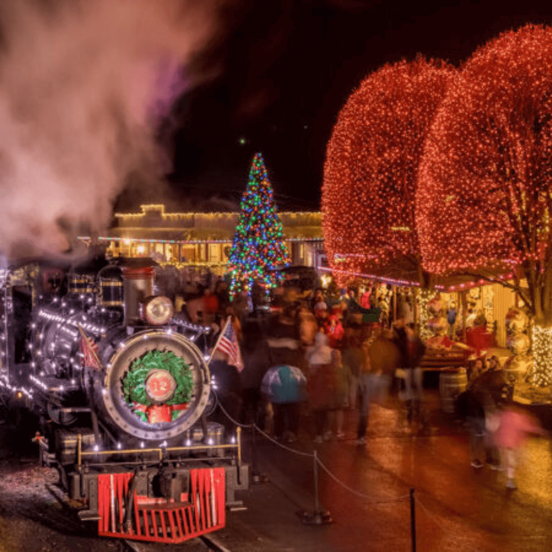 A wild west theme park decorated in holiday lights and a steam powered train decorated in lights.