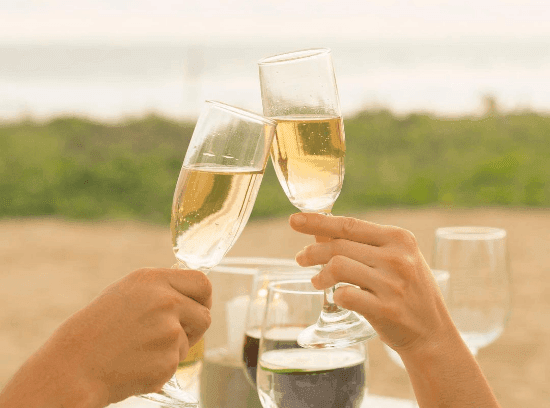 Close-up of toasting champagne near Marea Beachfront Villas