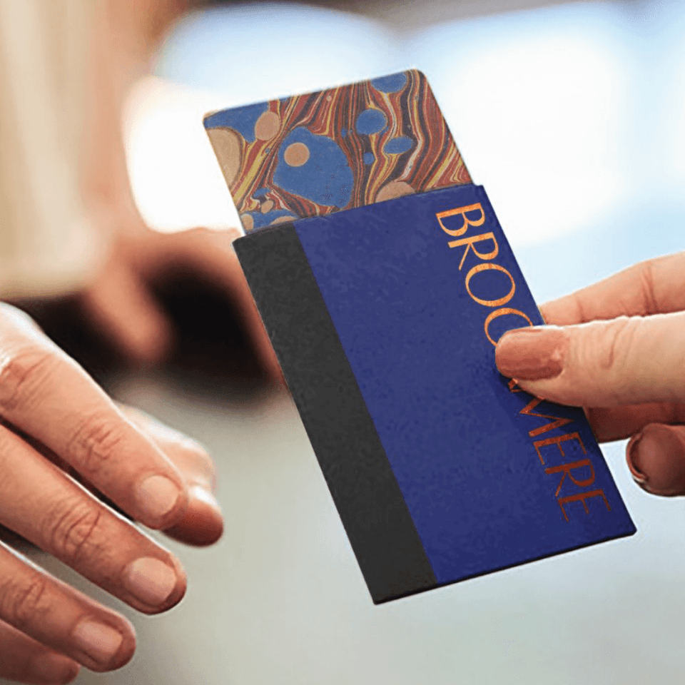 Close-up of a person handing over a hotel room card at Hotel Brookmere