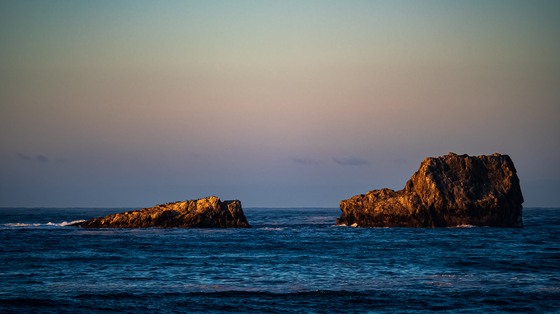 two large rocks out in the ocean