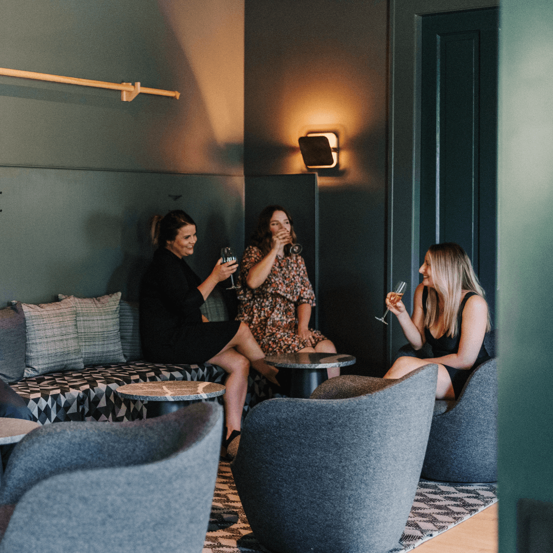 a group of girls haning at a bar