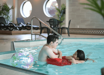 Couple relaxing in the indoor pool at Rodd Grand Yarmouth, a premier choice among hotels in Yarmouth, NS, Canada