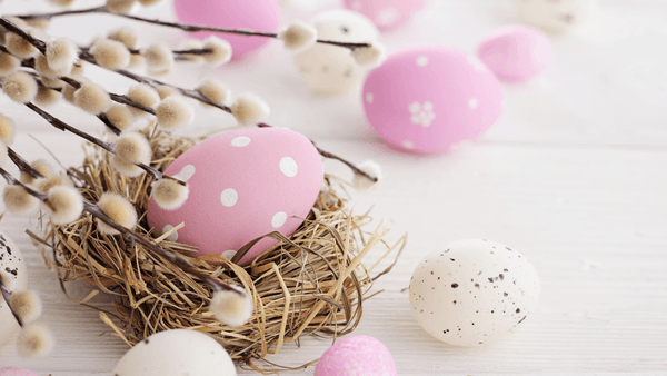 Easter Offer featuring decorated eggs and willow branches on a white table.