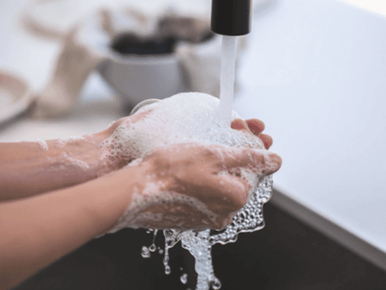 Closeup of a man washing his hands at Richmond Hill Hotel