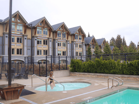 A lady get into the pool at Aava Whistler Hotel