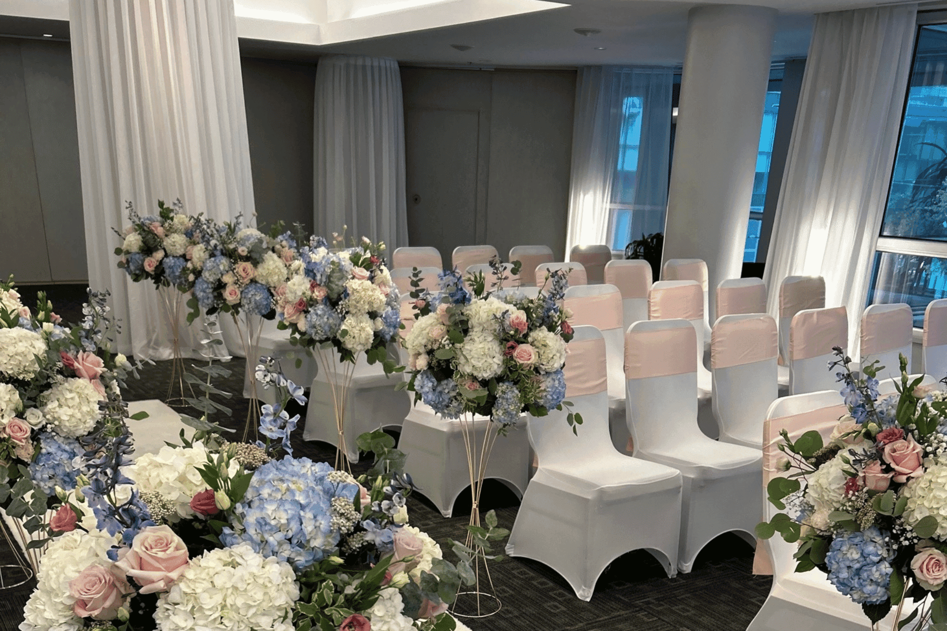 Unique wedding ceremony set-up with flower decorations at  Warwick Le Crystal