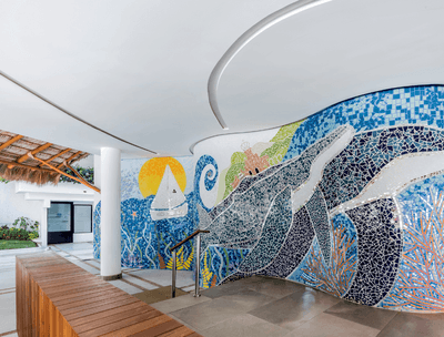 Mosaic mural showing a marine scene with a turtle, sailboat, and waves in hallway of Sunset Restaurant at Buenaventura Grand Hotel and Spa