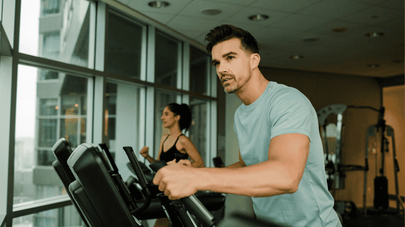 A man and woman working out in the gym at Warwick Le Crystal