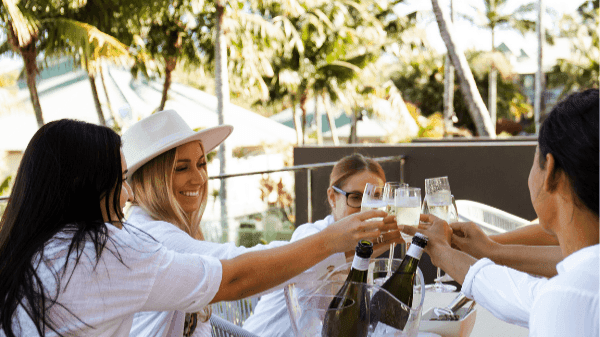 Four ladies toasting with champagne glasses in Sola Bar & Restaurant at the Novotel Sunshine Coast Resort