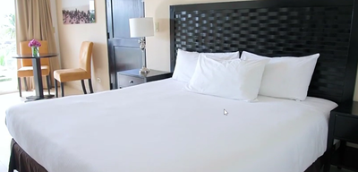 King bed & furniture in a room at Playa Blanca Beach Resort