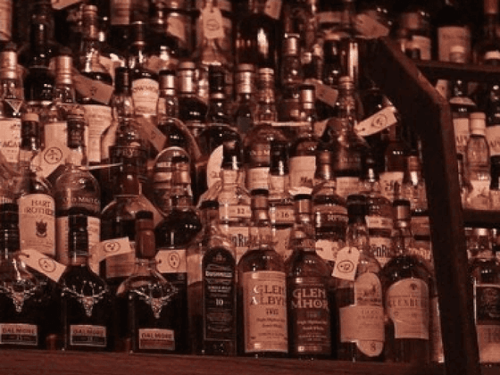 Collection of liquor bottles on a shelf at Nesuto Canberra