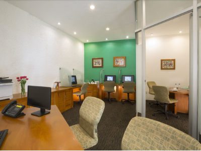 Desks & computers in a Business center at Gamma Hotels