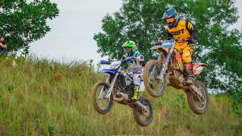 Two motocross riders mid-air in X Park near Sunway Hotel Big Box