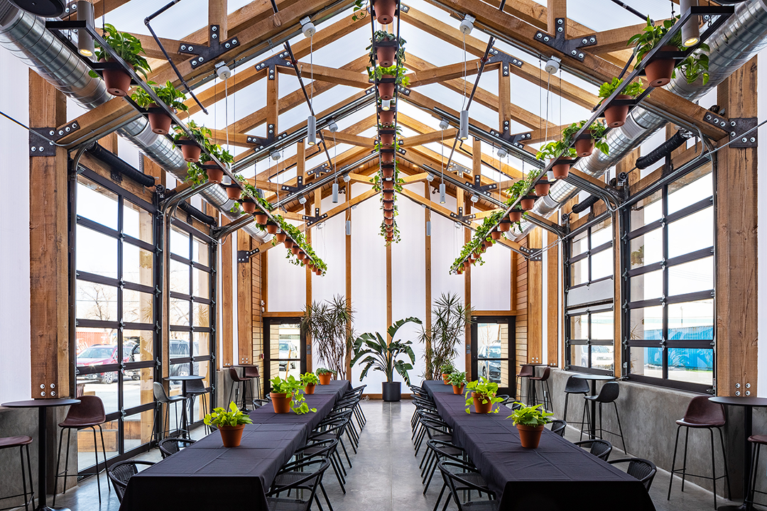 Arranged seats with plants in The Greenhaus at Kinship Landing
