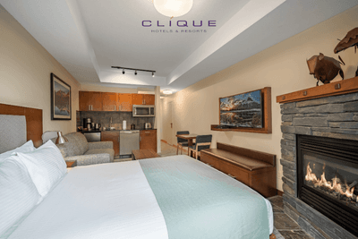 Suite at Falcon Crest Lodge features a comfortable king-size bed, a cozy living area with a fireplace