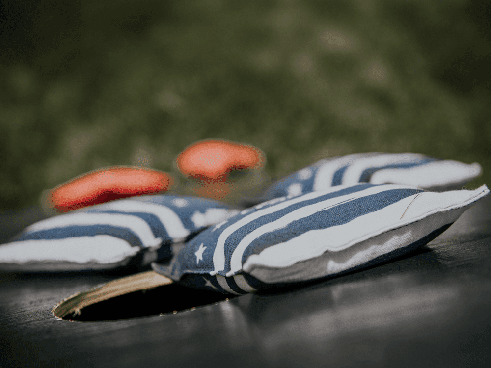 Close-up of cornhole bean bags set outdoors at Juniper Hill Inn