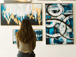 A woman looking at wall art at Key Largo Art Gallery near Bayside Inn Key Largo