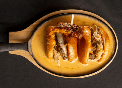 Gourmet sliders served in cheese sauce at Rodd Royalty, a top choice for restaurants in Charlottetown, Canada