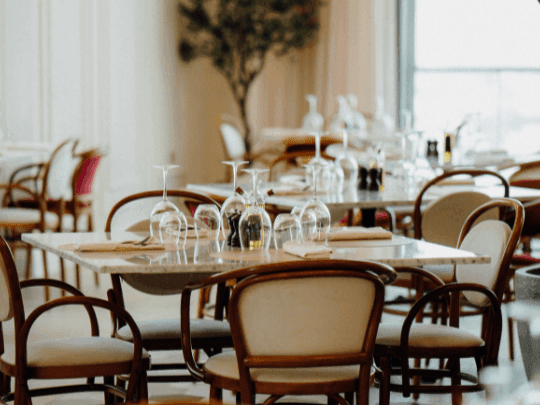 Dining tables arranged in Paparazzi Tuscan Restaurant at Paramount Hotel Midtown