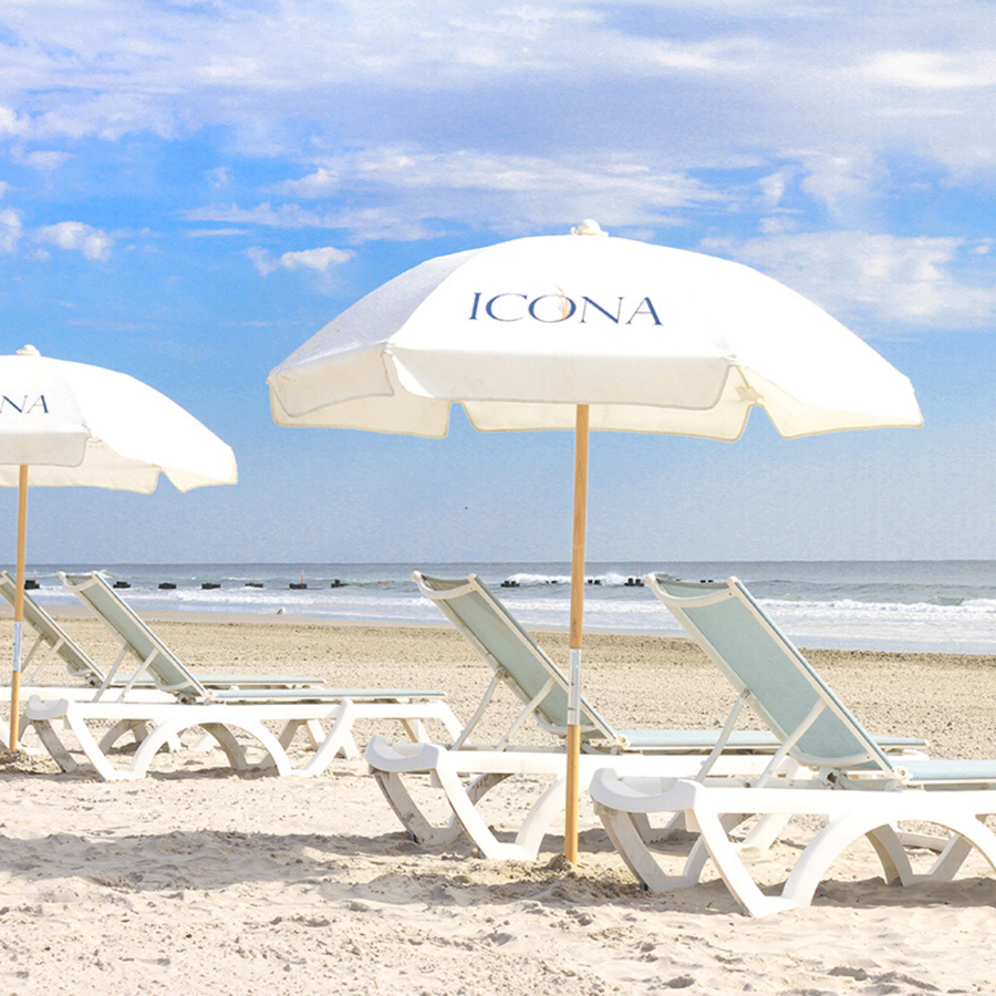 Sun loungers with umbrellas on the beach near ICONA Diamond