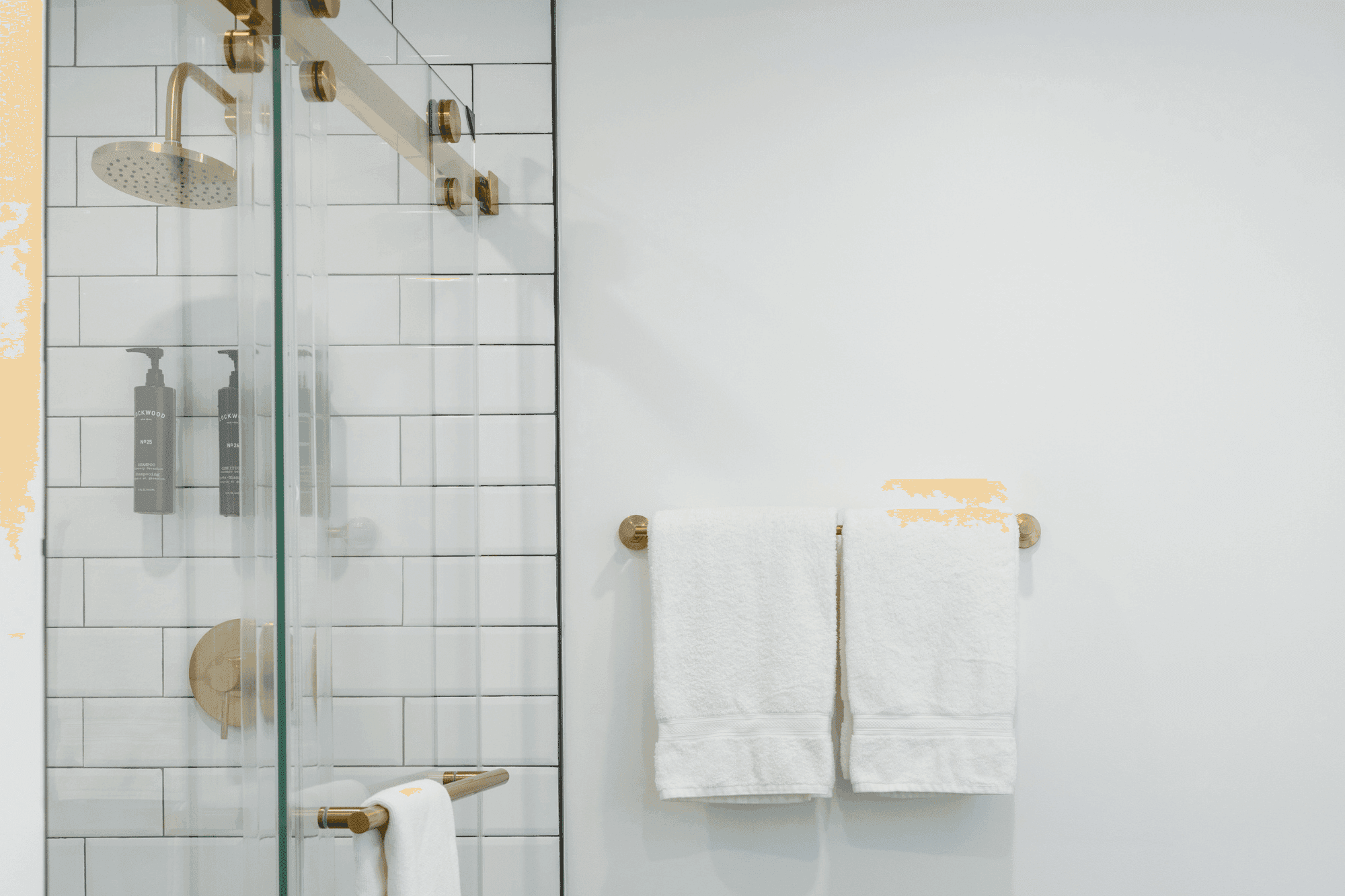 A bathroom with a shower and towels