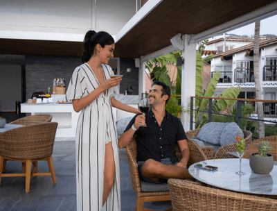 Couple looking at each other with wine glasses in Sky Bar at Buenaventura Grand Hotel and Spa