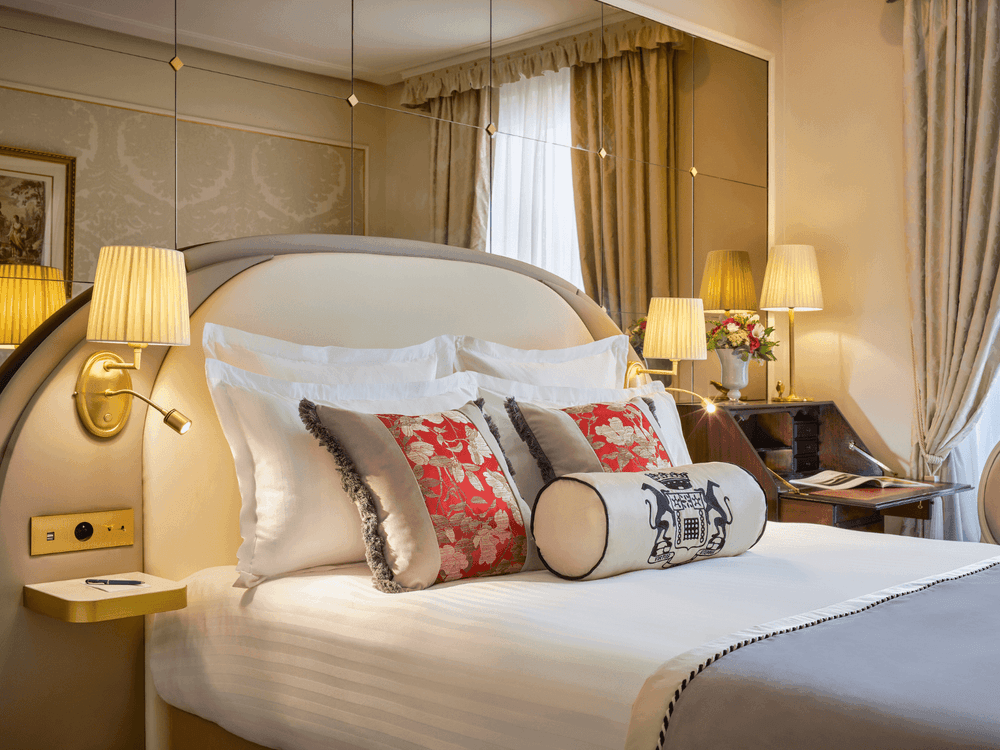 Bed under hanging wall lamp near work desk in Superior Double Room at Hotel Westminster Paris