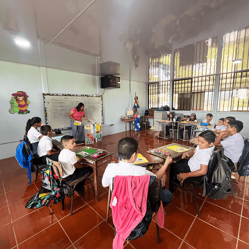 Group of students in a classroom learning activities at their desks near Hideaway Rio Celeste