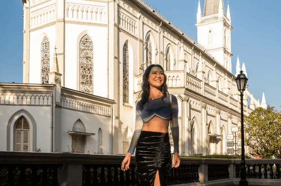 Lady posing for a picture by the CHIJMES Heritage building near Carlton Hotel Singapore