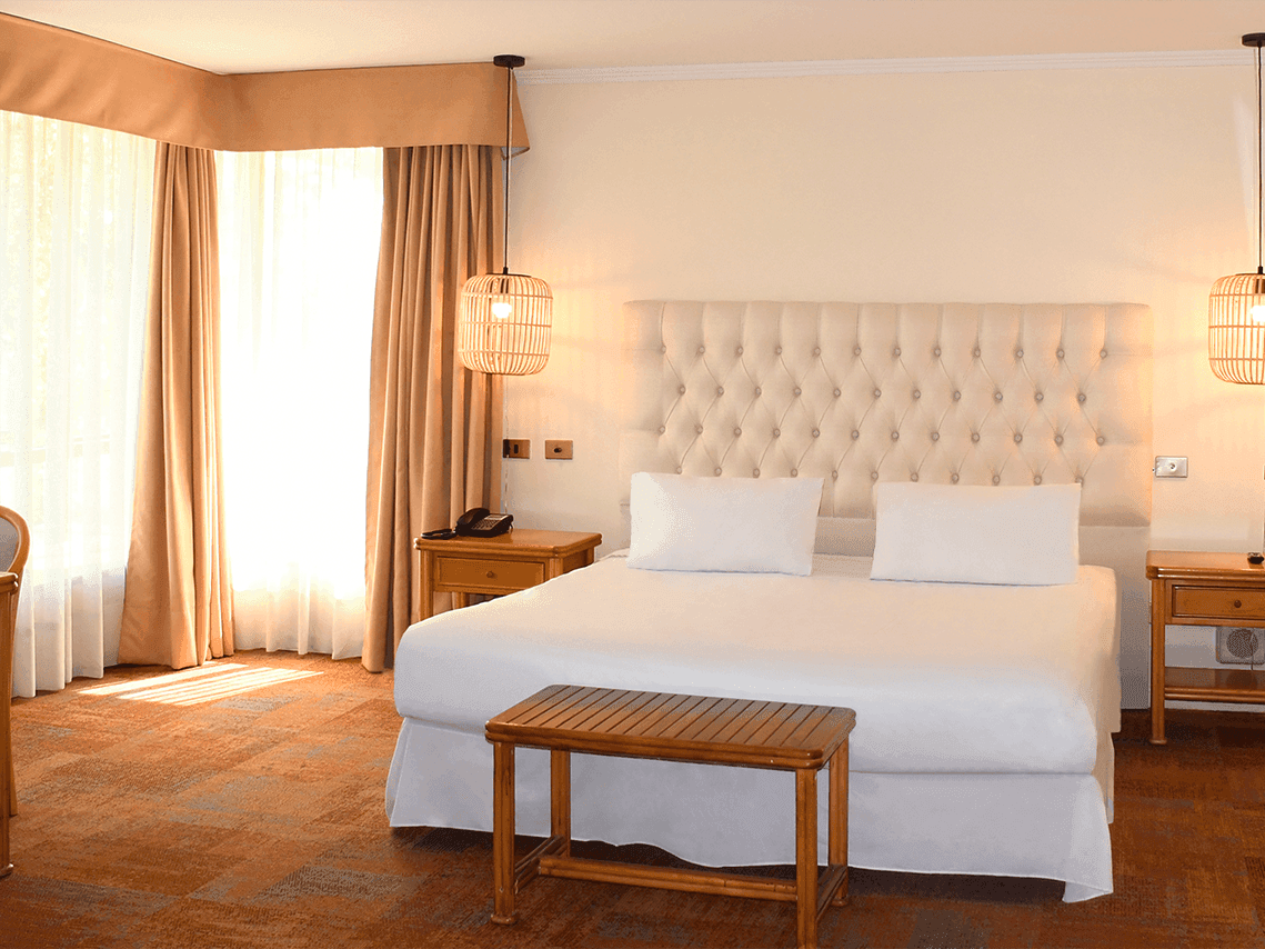 Bedroom arrangement in Junior Suite at Hotel Torremayor Lyon