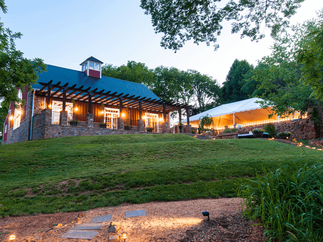 Exterior view of the Barn and Ruins, with stylized building surrounded by greenery at the Inn at Willow Grove