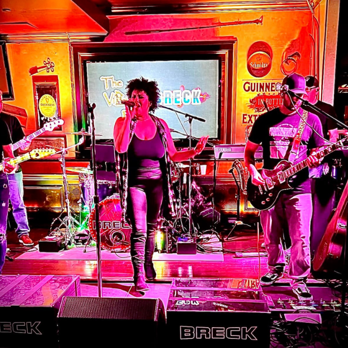 Band BRECK will play live music at ICONA Windrift in Avalon NJ this summer - 5 bandmates on stage pink & orange lighting