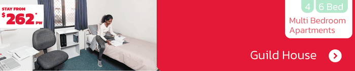 Student bedroom at Guild House featuring single bed, desk and chair – multi-bedroom apartments from $262 per week.