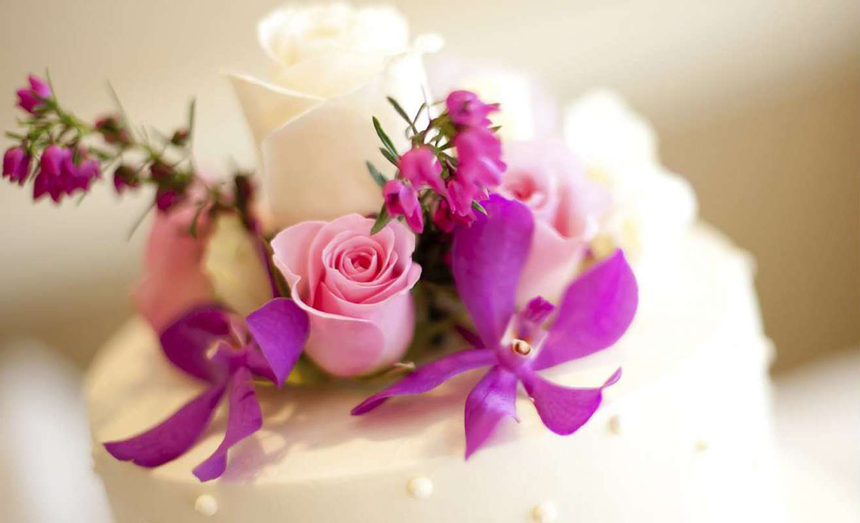 Close-up of a wedding cake with flowers at The Glenmore Inn & Convention Centre