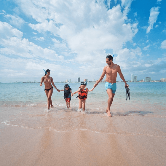 Family enjoying the beach near Viaggio Resort Mazatlan