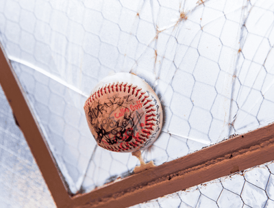 Close-up of a baseball on a netting at The Verb Hotel