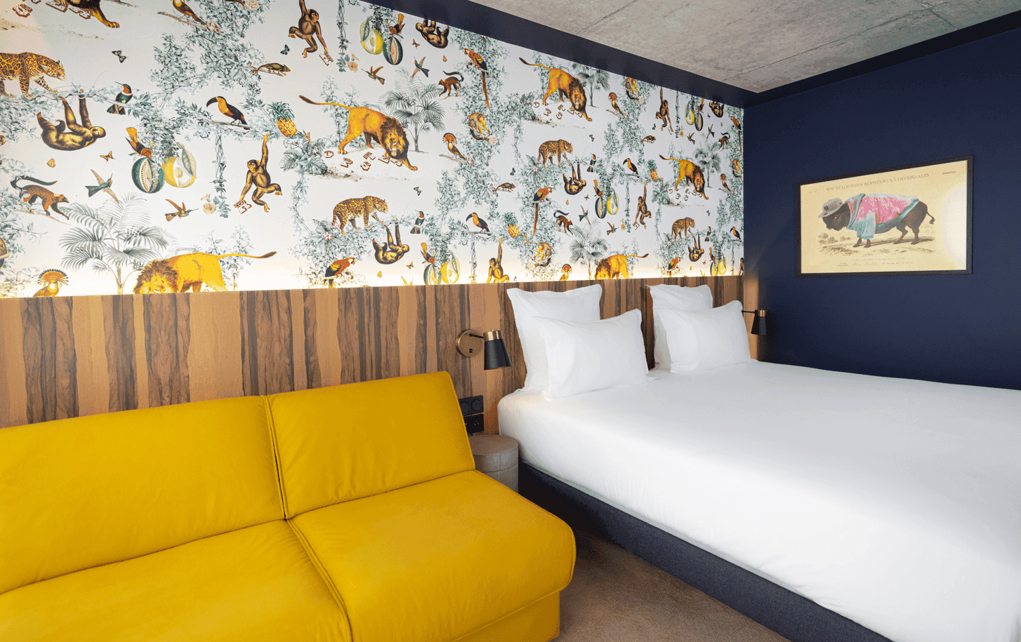 King bed & sofa in Ekip Room at Kopster Hotel Paris Ouest Colombes