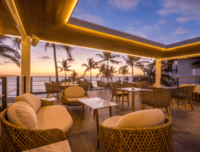 Oceanview terrace with wicker furniture at sunset in Sky Bar at Buenaventura Grand Hotel and Spa