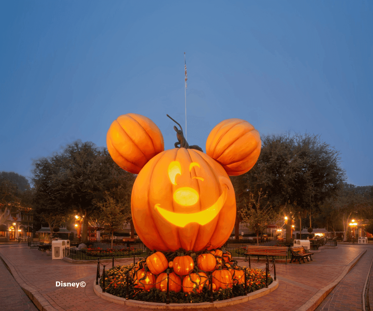A large Mickey Mouse pumpkin decoration at night