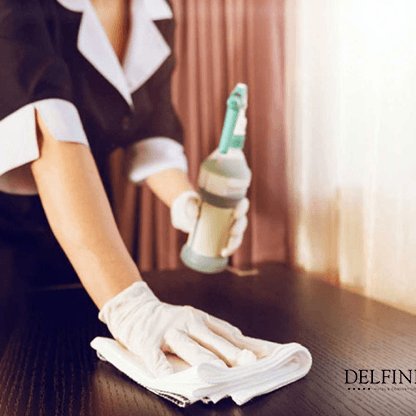 A maid disinfecting all the objects at Delfines Hotel
