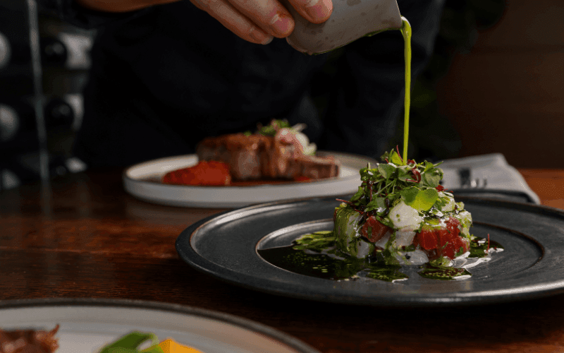 Close-up of Mediterranean salad on a black plate served at Pullman Sydney Olympic Park