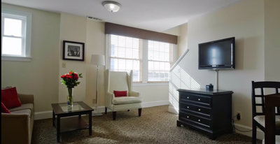 Living area with TV in Loft Suite at Artmore Hotel