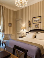 Bed with couches near window and work desk in Executive Room at Hotel Westminster Paris