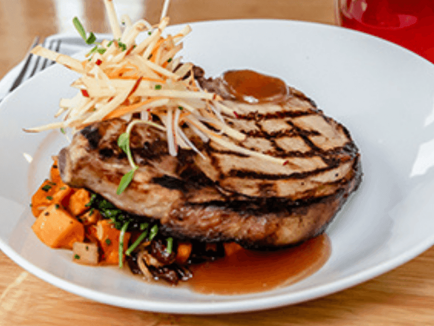 Close-up of a steak dish served at The Breakwater Inn & Spa