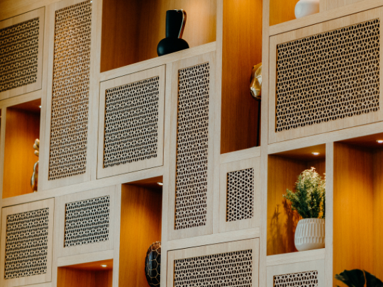 A wall with shelves and vases in CineScope Restaurant at Paramount Hotel Midtown