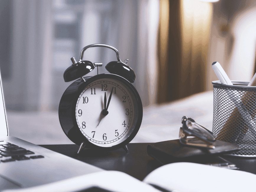 Close-up of an alarm, books & pen at Carlton Hotel Singapore