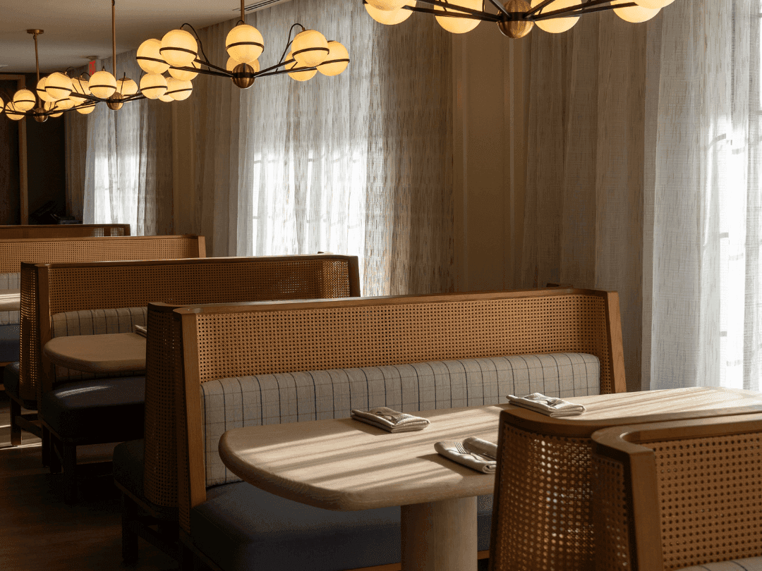 dining booths at Regent Restaurant and Bar with warm sunbeams illuminating the tables